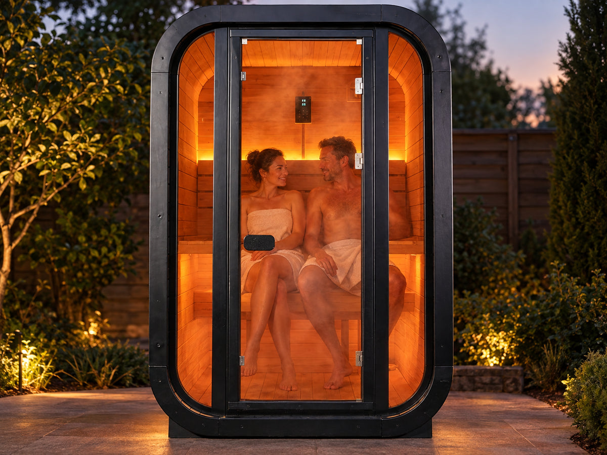 1-2 Person Outdoor Traditional Steam Sauna, two people seated side by side on the interior bench, shoulders relaxed