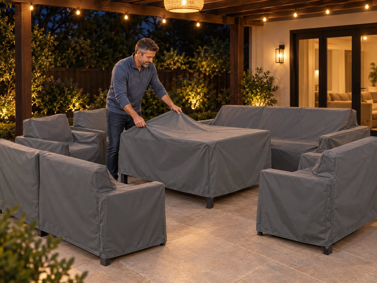 Aluminum Patio Furniture Set, man draping a fitted waterproof cover over the table and chairs, backyard patio under a pergola