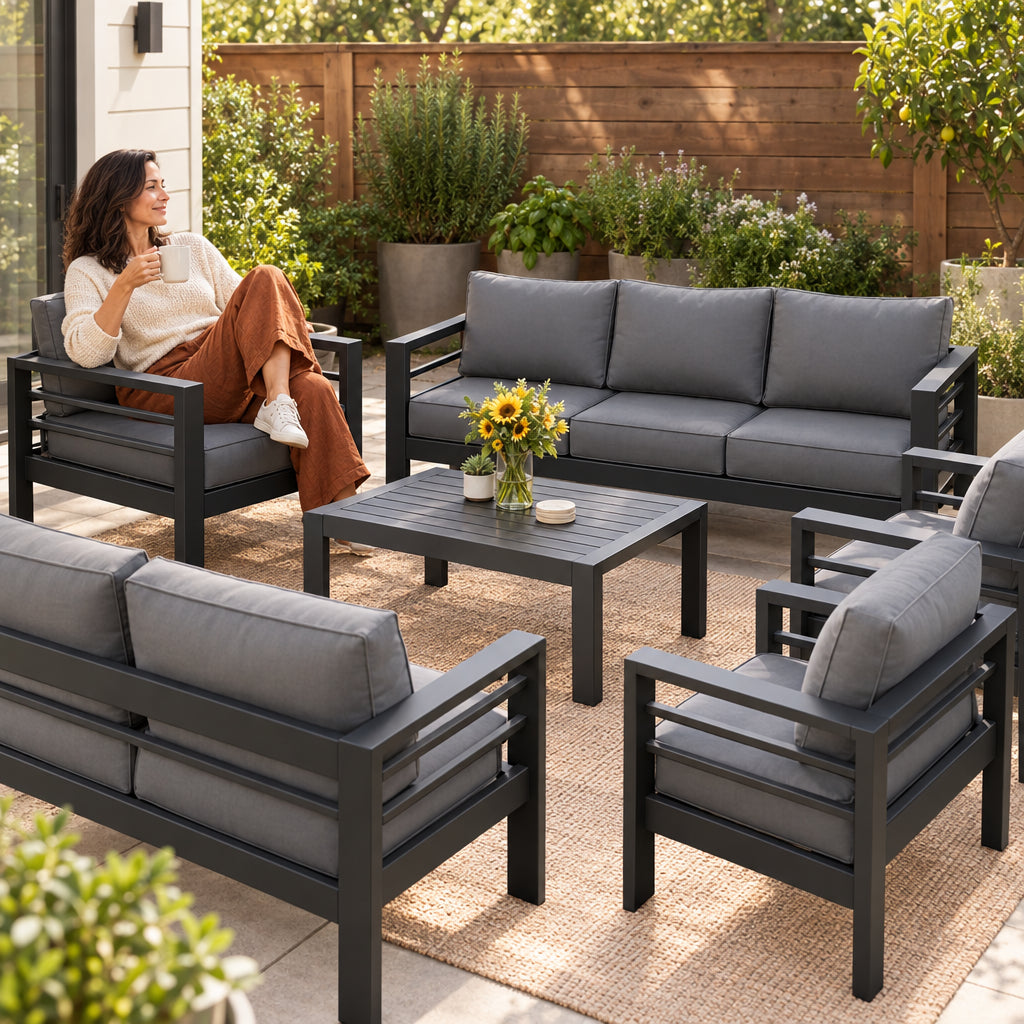 Aluminum Patio Furniture Set, woman sitting sideways in an aluminum chair, coffee mug in hand, at ease