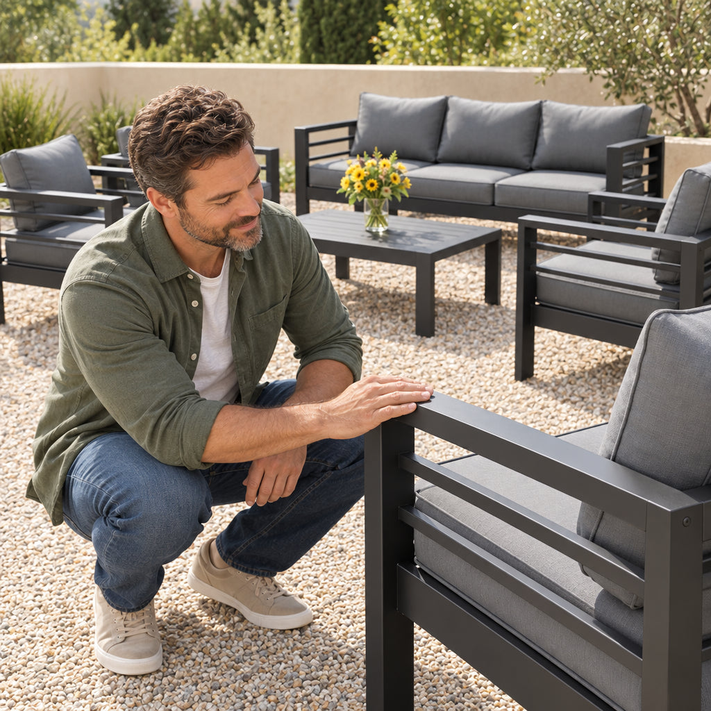Aluminum Patio Furniture Set, man crouching beside the chair, running a hand along the frame with a nod of approval